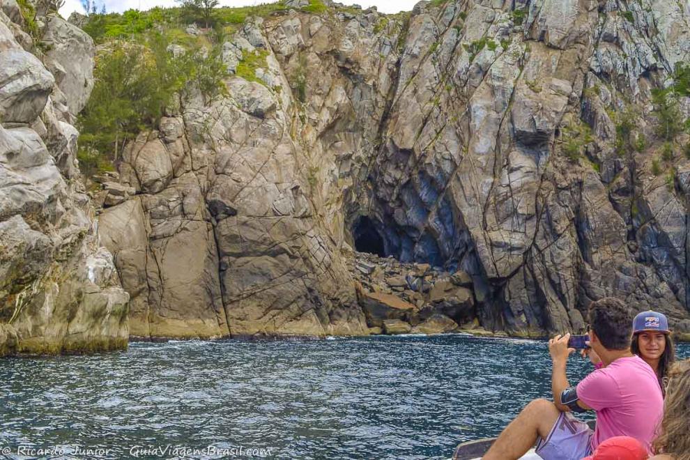 Imagem de turistas registrando as belezas naturais de Arraial do Cabo.